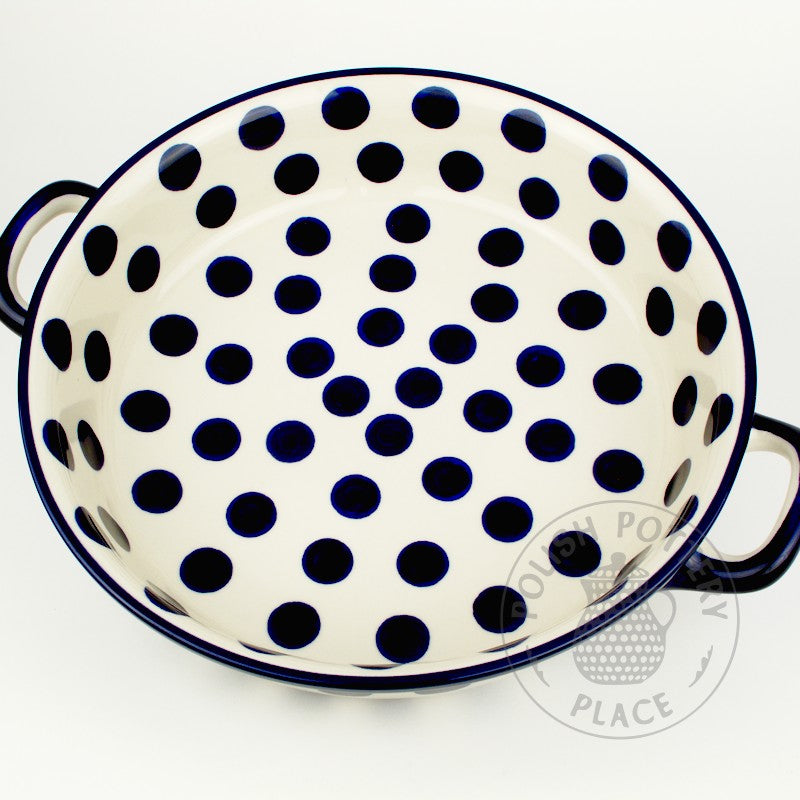 Large round polish pottery baker dish with handles and a blue on white big dots pattern